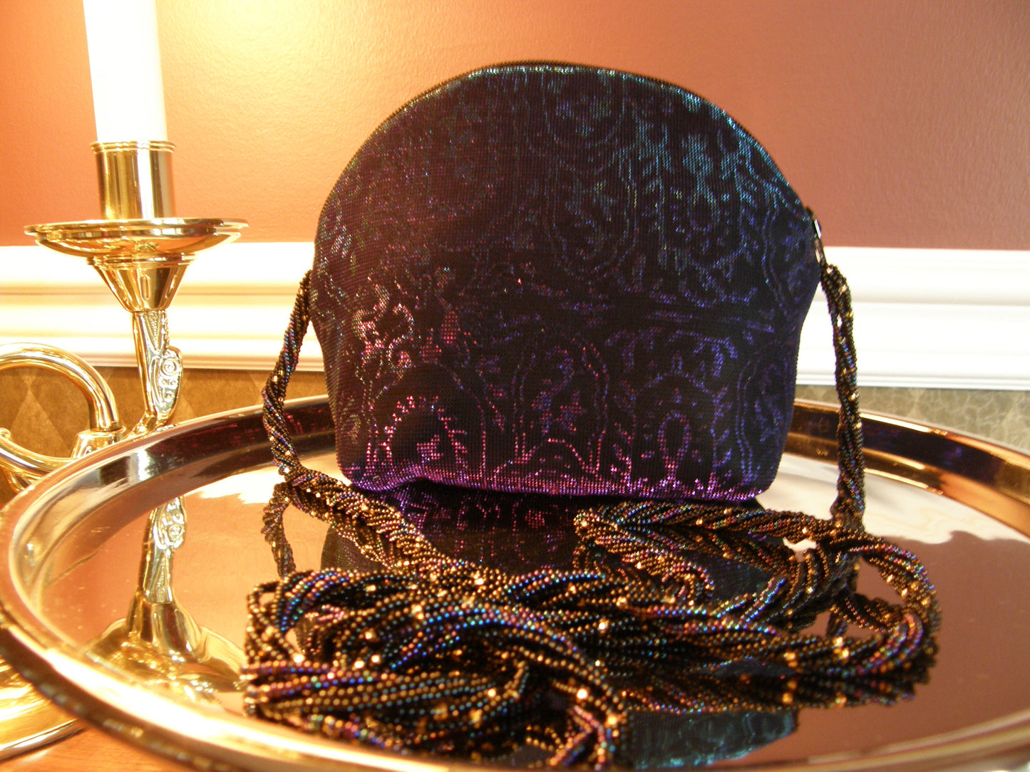 Iridescent Evening Bag by Jenny Jag-Wear Design. This is a stunning small evening bag made from purple, black, and turquoise fabric. The hand-crafted beaded handle is comprised of multiple strands of seed beads in the same colour hue as the fabric. Zipper enclosure. Can be carried as a small clutch or carried over the shoulder with the  long beaded handle. This small purse is hand sewn and hand-crafted. The Liza Collection by Jenny Jag-Wear Design.