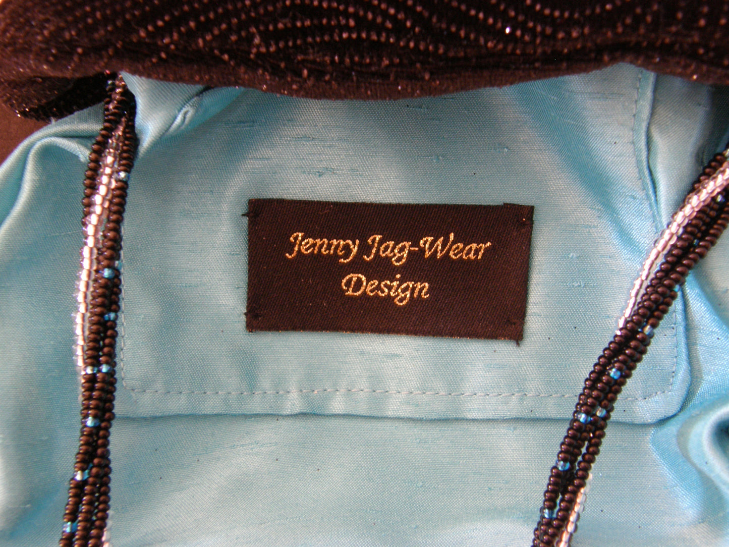 Black and Silver Evening Bag from Jenny Jag-Wear Design.  Photo depicts the inside lining to this evening bag in peacock  satin. The Merle Collection from Jenny Jag-Wear Design.