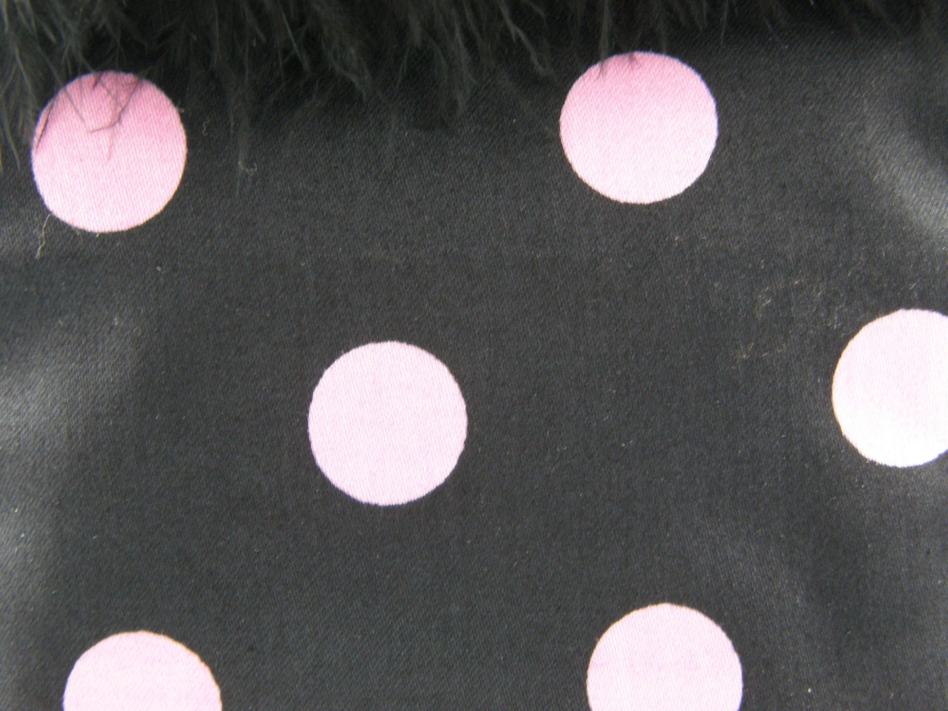 Black and Pink Evening Bag from Jenny Jag-Wear Design. Photo shows close up of the black and bubble-gum pink polka dotted fabric. The merle collection by Jenny Jag-Wear Design.