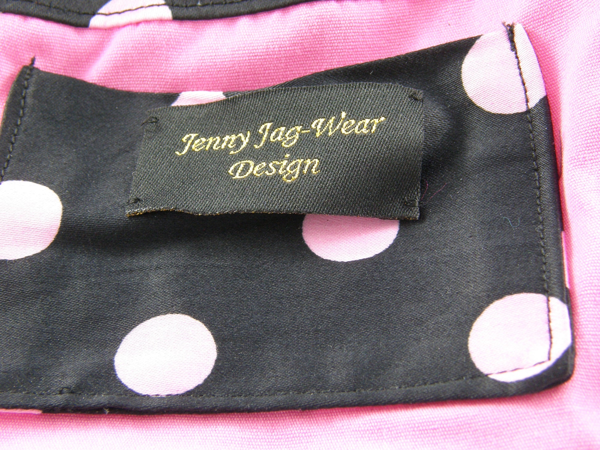 Black and Pink Evening Bag from Jenny Jag-Wear Design. The photo shows inside lining to this compact ladies evening bag. The purse is lined in bubble gum pink with inside pocket in the same black and pink polka dots as the outside. The Merle Collection from Jenny Jag-Wear Design.