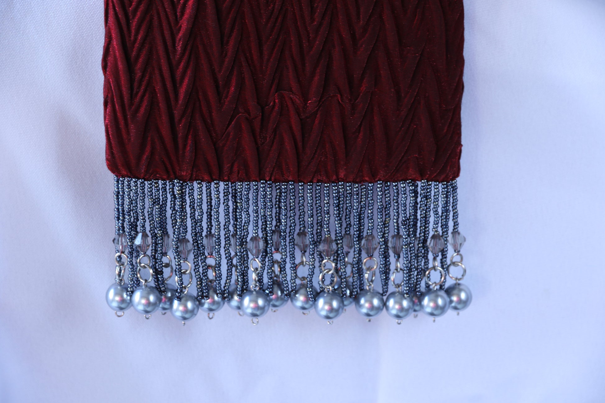 Burgundy Evening Bag from Jenny Jag-Wear Design. Close up photo showing the beaded fringe along the bottom o this small ladies evening bag. The Zara Collection from Jenny Jag-Wear Design.