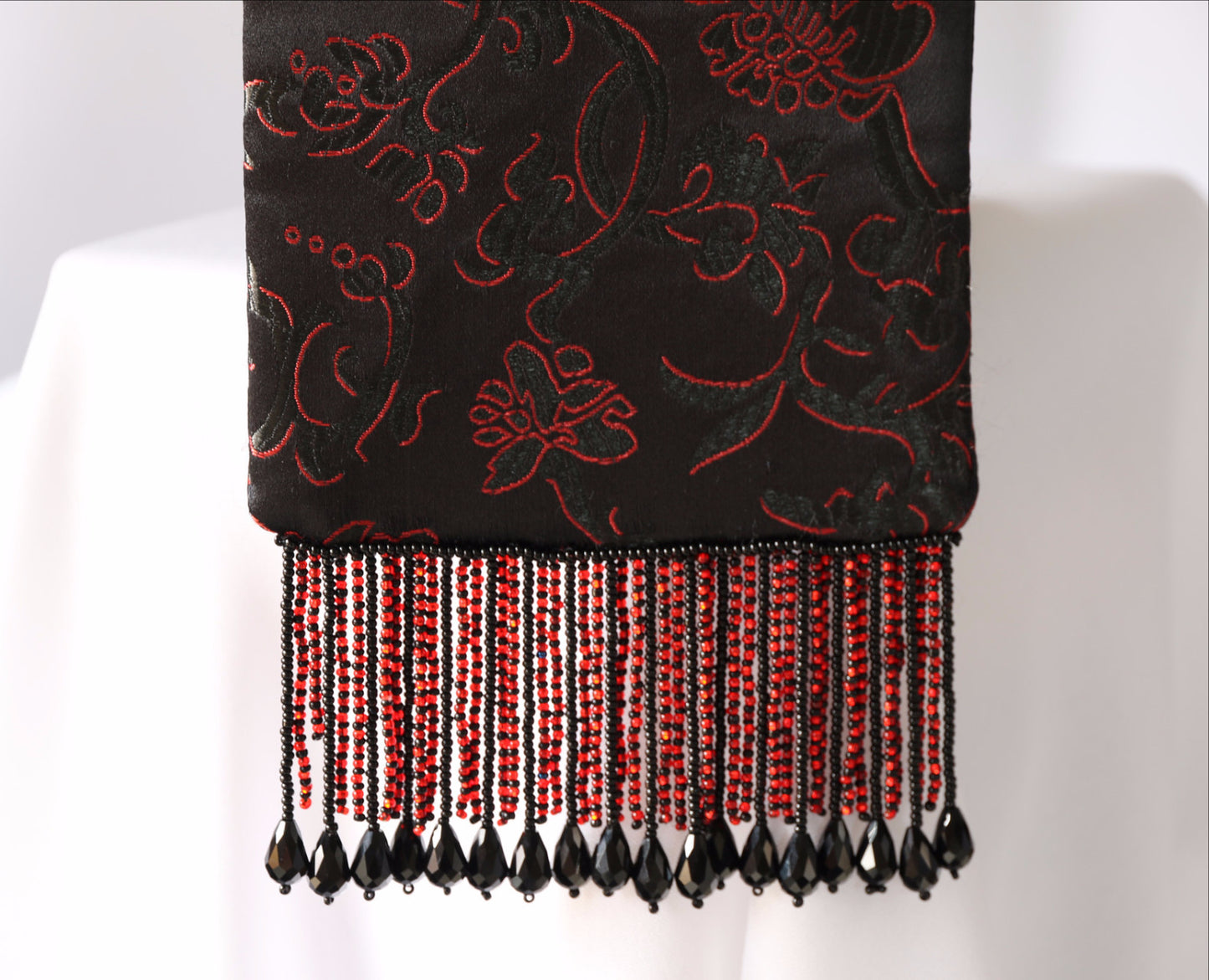 Black and Red Evening Bag from Jenny Jag-Wear Design. Photos showing close up image of the red and black brocade fabric in floral motif, and beaded fringe. The fringe is made up of black tear drop beads and red and black seed beads. The Zara Collection from Jenny Jag-Wear Design.