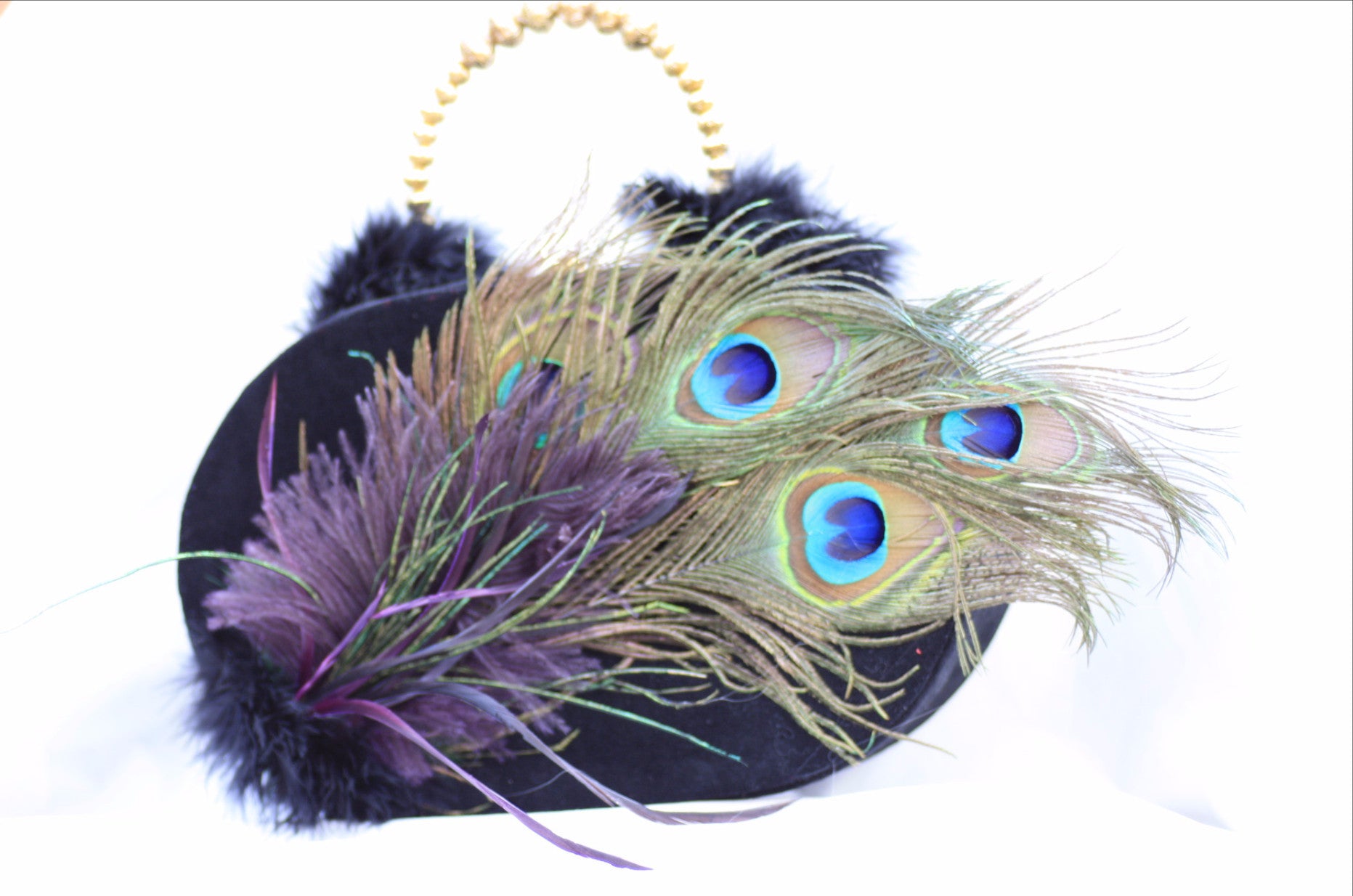 novelty wood based purse designed in black velvet and embellished with peacock feathers and gold handle